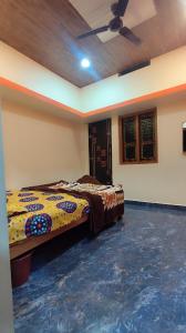 a bedroom with a bed in a room with a ceiling at Durga Devi Home stay in Hospet