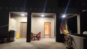 a room with a table and chairs and lights at Durga Devi Home stay in Hospet