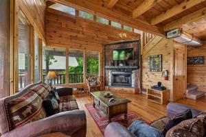 a living room with a couch and a fireplace at The Honeymoon Sweet #63 by Venture Smoky Mountains in Sevierville