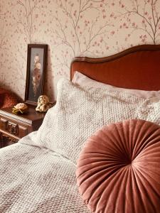 a bedroom with a bed with a large pillow on it at Vintage Boutique Room in Lavra