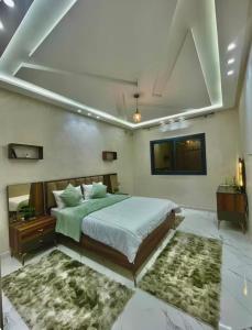 a bedroom with a large bed and two rugs at Fes Golf Residence in Fez