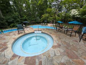 a small pool with a table and chairs around it at Haven Home - Deck, Grill, Hiking, Pool Access, Games, Community Playground and Tennis Courts in Berkeley Springs