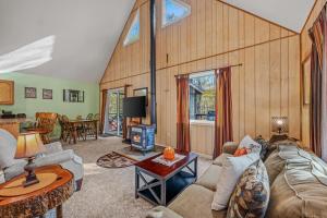 a living room with a couch and a table at Trails End River Retreat - Riverside in Berkeley Springs