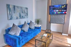 a blue couch in a living room with a table at Modern Family & Contractor Home - Free Parking - Garden - Sleeps 6 - Fast WiFi - in Bristol