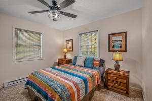 a bedroom with a bed and a ceiling fan at Trails End River Retreat - Riverside in Berkeley Springs