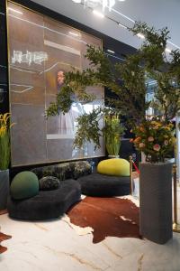 a room with some plants and a large screen at Townplace Hotel & Apartments in Port Harcourt