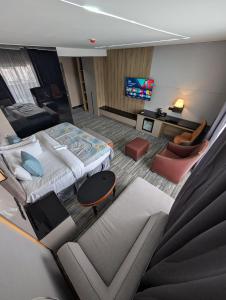 a hotel room with a large bed and a couch at Townplace Hotel & Apartments in Port Harcourt
