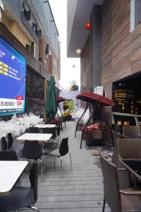a restaurant with tables and chairs and a large screen at Townplace Hotel & Apartments in Port Harcourt +7 photos
