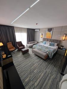 a large hotel room with a bed and a couch at Townplace Hotel & Apartments in Port Harcourt