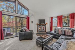 a living room with two couches and a fireplace at Woods Song -- Hot Tub - Pet Friendly - Wifi - King Bed - Woods Resort - Golf Nearby - Pool Pass - Spa - Grill - Fireplace in Hedgesville