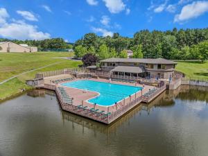 an image of a swimming pool on a river at Woods Song -- Hot Tub - Pet Friendly - Wifi - King Bed - Woods Resort - Golf Nearby - Pool Pass - Spa - Grill - Fireplace in Hedgesville