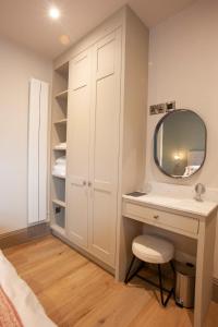 a bathroom with a sink and a mirror at Causeway Squarings in Bushmills
