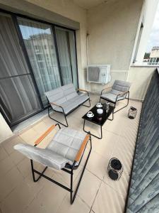 a patio with two chairs and a table on a balcony at ThePlaceToBe2 in Brăila