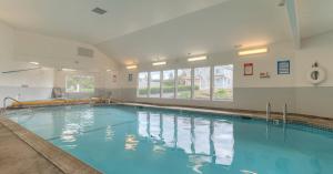 a large indoor swimming pool with blue water at Oceanfront Condo - Second Floor - Pet Friendly in Lincoln City
