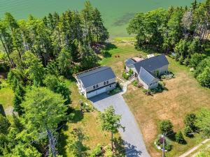 an overhead view of a house on a hill with trees at Newly-built waterfront home with fast WiFi, furnished deck, & washer/dryer in Waldoboro