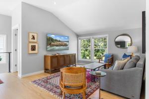 a living room with a couch and a table at Newly-built waterfront home with fast WiFi, furnished deck, & washer/dryer in Waldoboro +27 photos