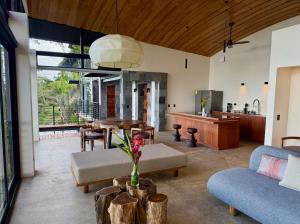 a living room with a couch and a table at Origins Astral in Bagaces