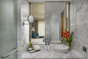 a bathroom with a sink and a mirror at Hotel DSR Krone New Delhi in New Delhi +24 photos