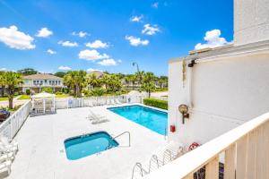a balcony with a swimming pool and a building at Ocean Towers Resort in Myrtle Beach