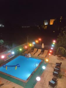 a swimming pool at night with lights on at Panorama RABATI in Akhaltsikhe