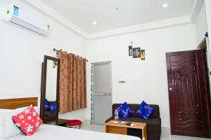 a room with a bed and a couch and a table at Diya Homestay in Rāmpur Hāt