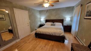 a bedroom with a bed and a ceiling fan at Charlotte Garden Bed and Breakfast in Niagara-on-the-Lake +83 photos