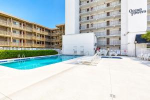 a view of the pool at the covenant properties apartment complex at Ocean Towers Resort in Myrtle Beach +1 photo