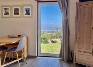 a room with a table and a sliding glass door at The Fig Boutique Suites in Salir de Porto