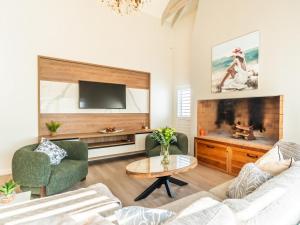 a living room with a couch and a tv at Luxe Pearl in Paternoster +9 photos