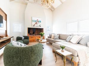 a living room with a couch and a chair at Luxe Pearl in Paternoster