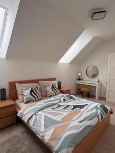 a bedroom with a large bed in a attic at Pobyt na Mlýně in Červená Voda