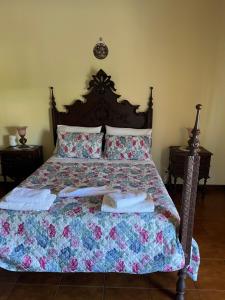 a bedroom with a bed with towels on it at Propriedade dos Seixos in Moledo +1 photo