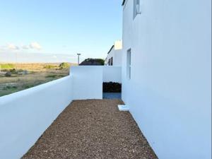 a white house with a view of the ocean at Luxe Pearl in Paternoster