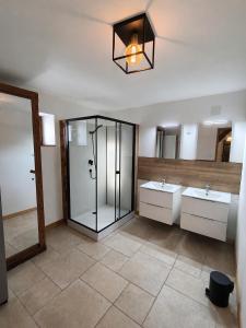 a bathroom with two sinks and a glass shower at Domaine de Beau Site in Peyrat-de-Bellac +44 photos