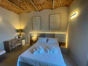 a bedroom with a bed with two slippers on it at Calabianca in Giglio Porto
