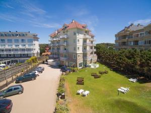 a large apartment building with a lawn in front of it at Costa Carilo Apart de Mar By HS in Carilo