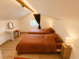 a bedroom with two beds and a desk at Domaine de Beau Site in Peyrat-de-Bellac
