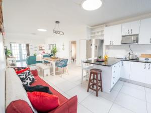 a kitchen and living room with a couch and a table at Ivory Pearl in Paternoster