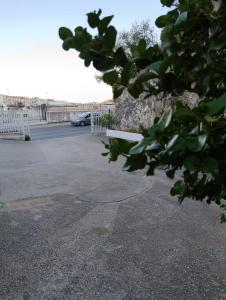 a parking lot with a white fence and a parking lot at Bed and Breakfast Brezza Marina in Mattinata