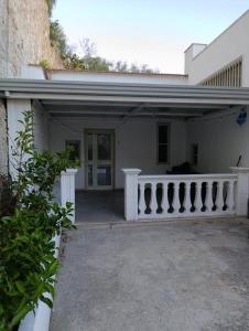 a white house with a porch and a balcony at Bed and Breakfast Brezza Marina in Mattinata +40 photos