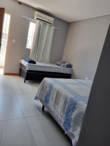 a bedroom with a bed and a window in it at Hotel Boneario in Vitória da Conquista
