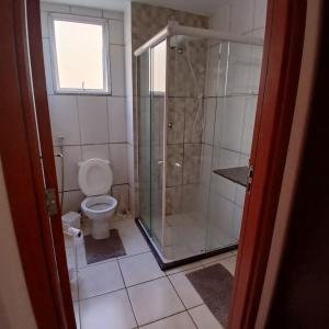 a bathroom with a shower and a toilet at Apartamento Sossego! in Uberaba