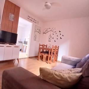 a living room with a couch and a table at Apartamento Sossego! in Uberaba