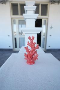 a red object sitting on top of a table at Bed and Breakfast Brezza Marina in Mattinata