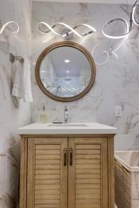a bathroom with a sink and a mirror at Sweet Lancaster Apt. A in Lancaster +30 photos