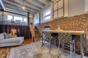 a living room with a brick wall and a bar at Sweet Lancaster Apt. A in Lancaster