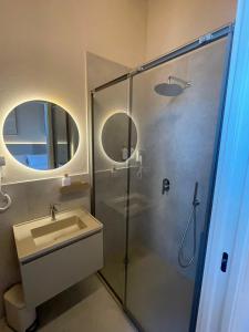 a bathroom with a glass shower and a sink at Calabianca in Giglio Porto +14 photos