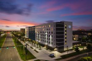 a large building on a city street at night at EVEN Hotel Orlando Universal Blvd by IHG in Orlando
