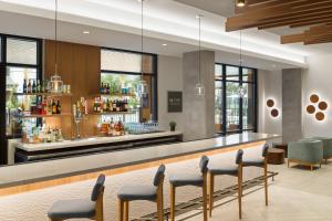 a bar in a hotel lobby with chairs at EVEN Hotel Orlando Universal Blvd by IHG in Orlando