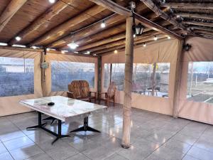 a dining room with a table and chairs in a house at Entre Viñedos in Ciudad Lujan de Cuyo